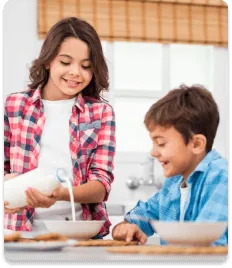 Children enjoying a glass of Khalis milk at breakfast